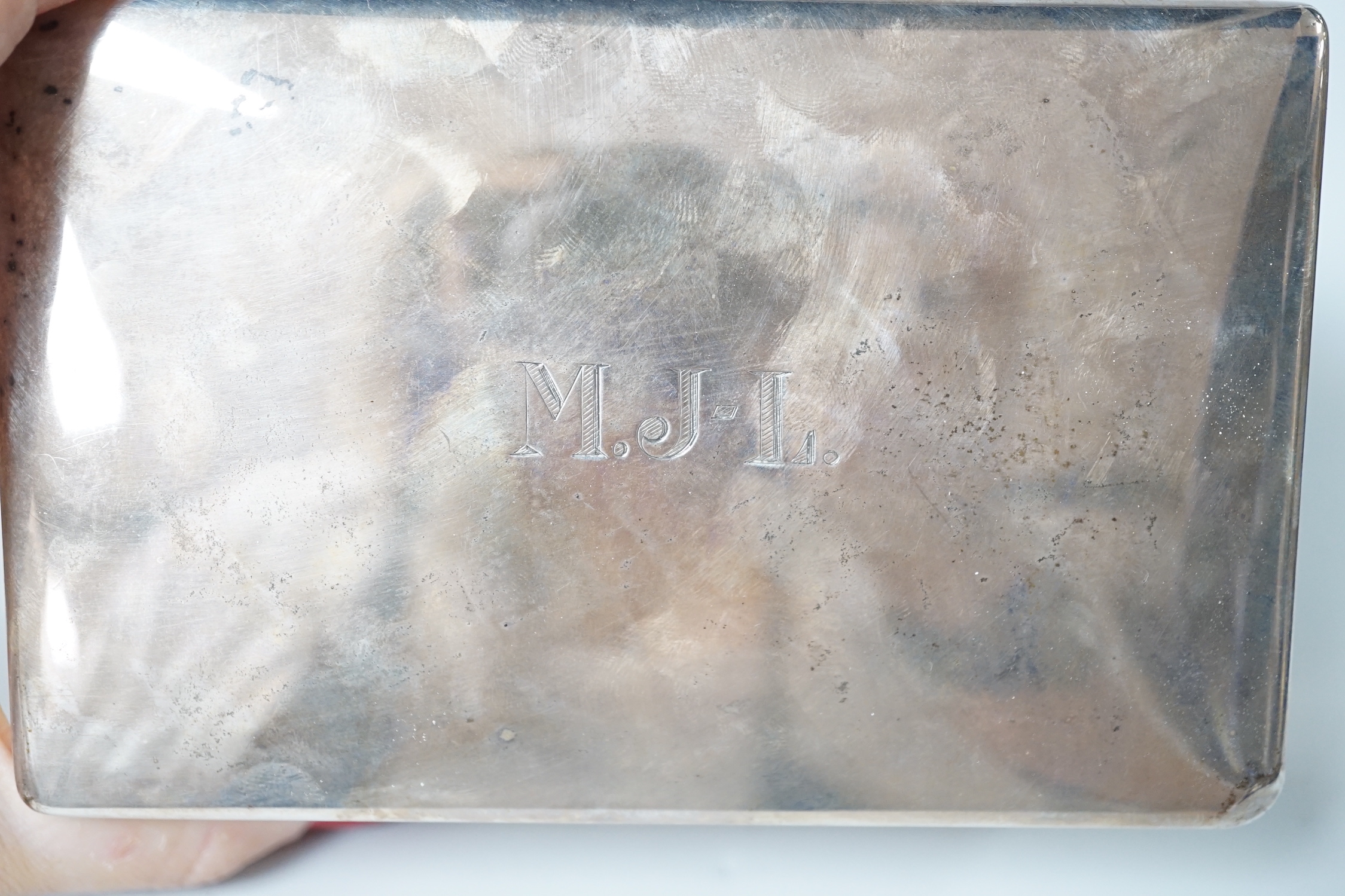 A George VI plain rectangular silver cigarette box with initials MJL, Mappin & Webb, London 1945, 14cm, gross 479 grams